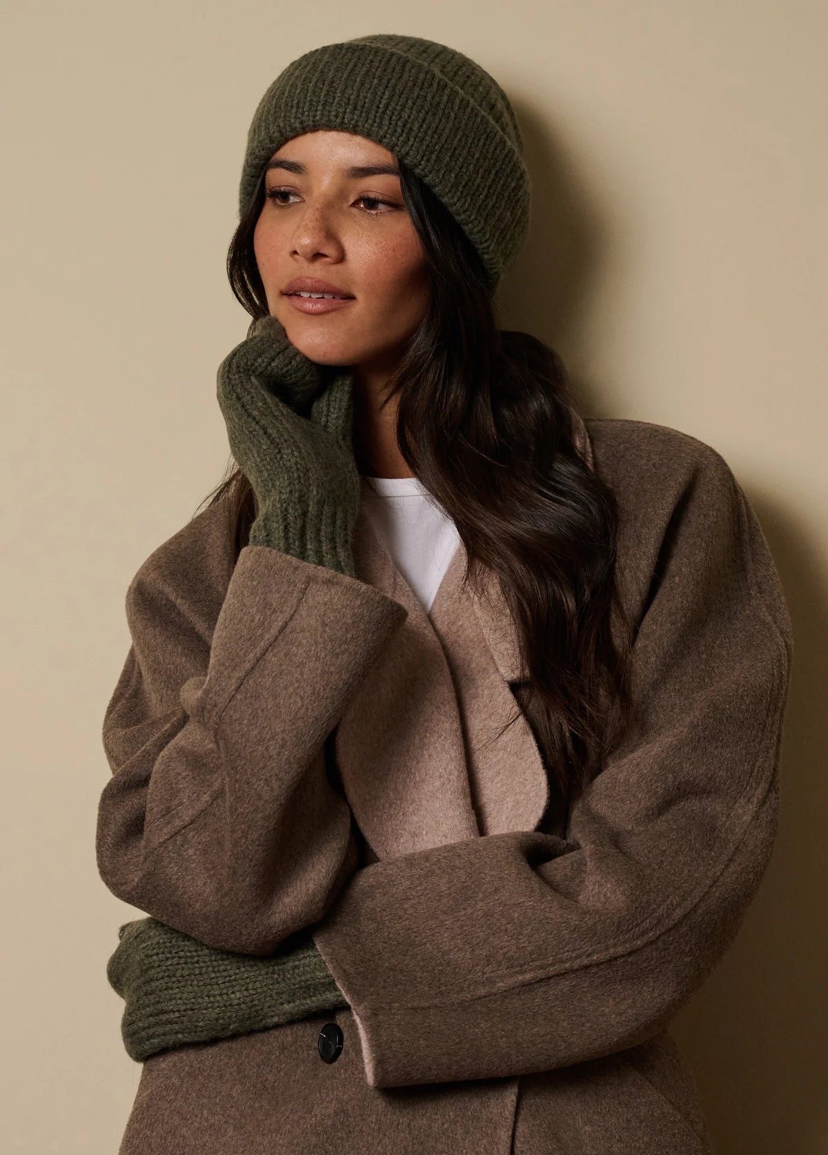 Favorite Daughter olive green braided knit beanie styled with brown winter coat