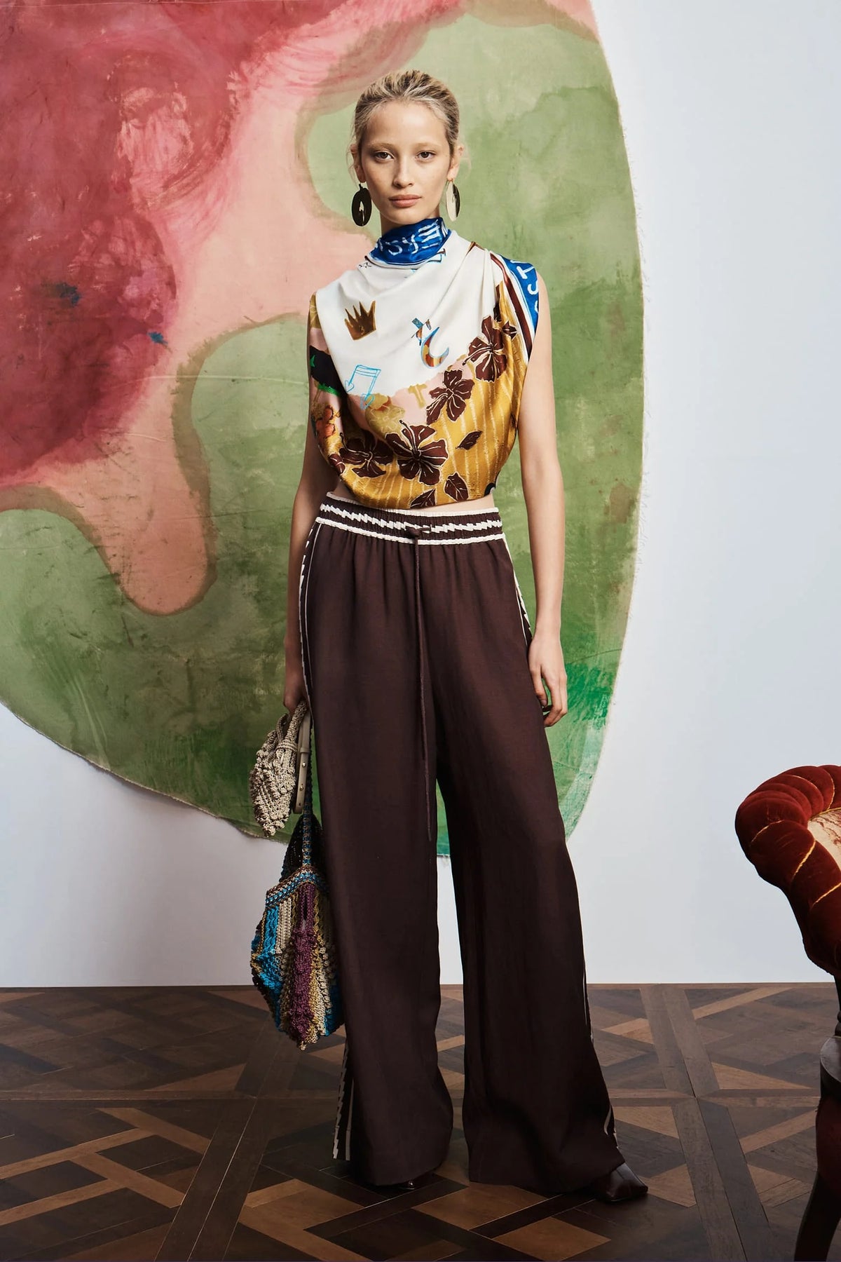 ALEMAIS Tangible Love Scarf styled on model with wide-leg trousers.
