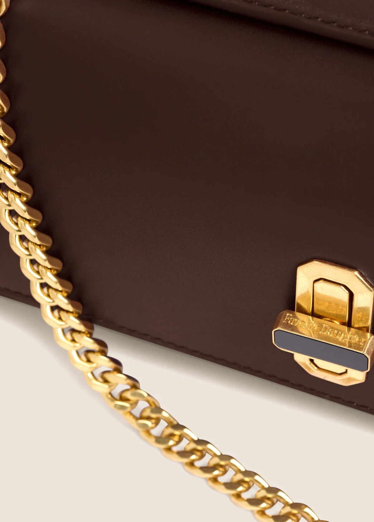 Close-up of Favorite Daughter Heirloom Clutch gold-tone chain and front clasp