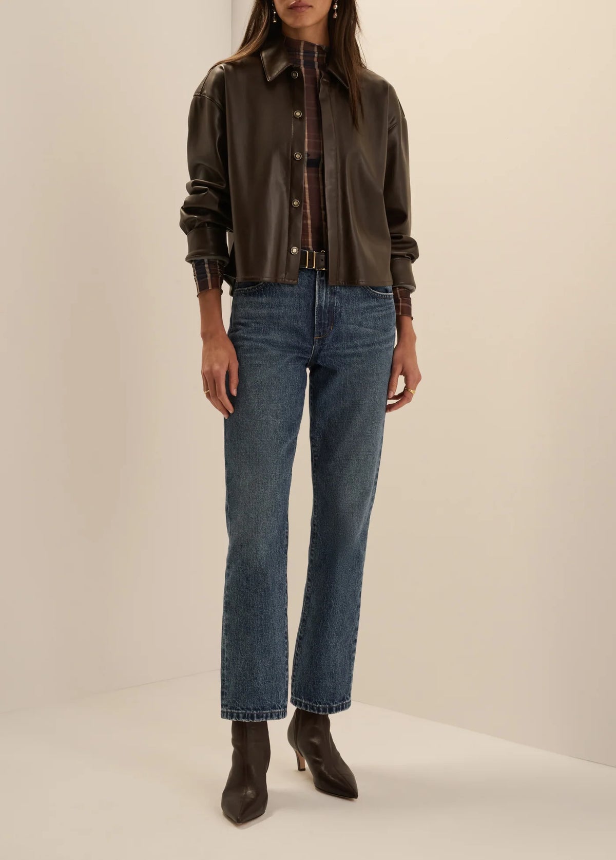 Favorite Daughter brown leather button-down shirt paired with straight-leg denim jeans.