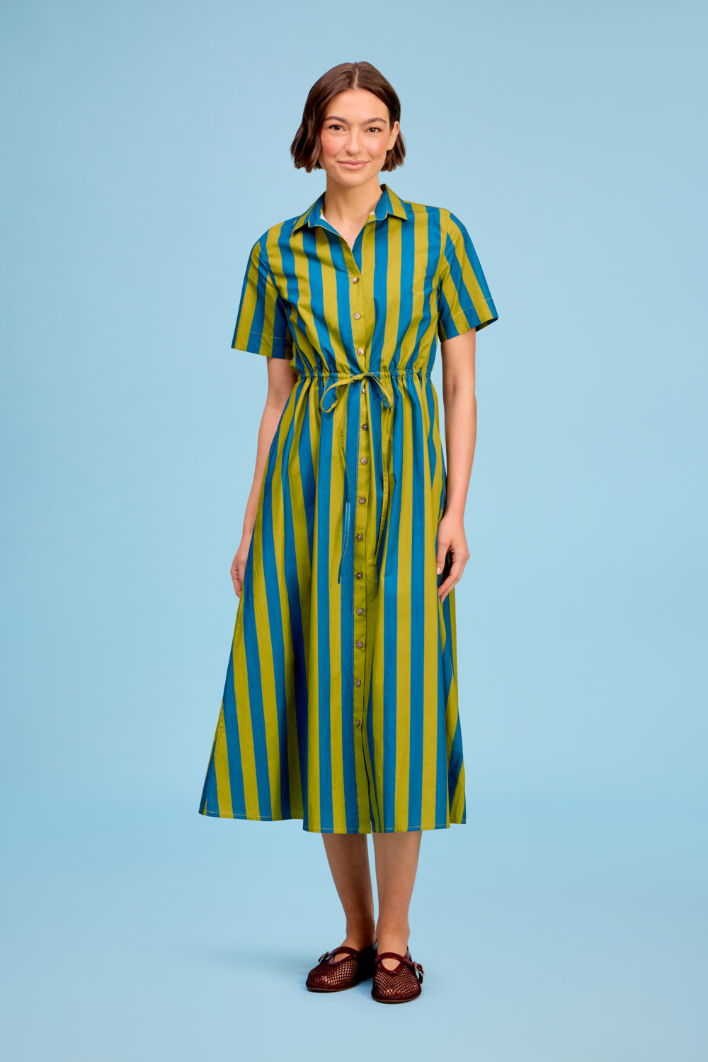 LIVRO Sutton Dress in green, blue and yellow vertical stripes with a collared neckline, short sleeves and tie waist.