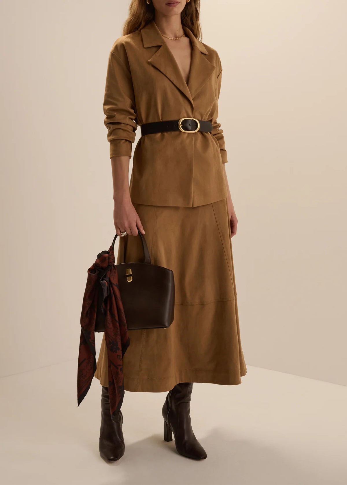 Favorite Daughter Aspen camel midi skirt styled with matching blazer, black belt and boots
