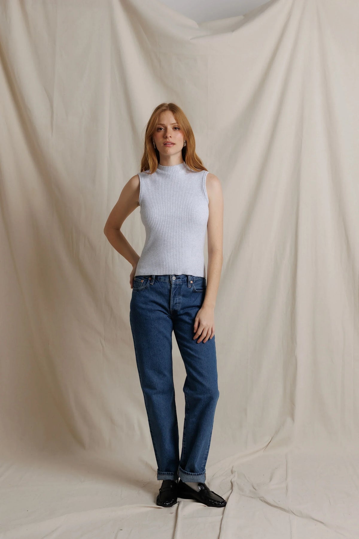 Model wearing Violet sleeveless sweater by Perfect White Tee with denim